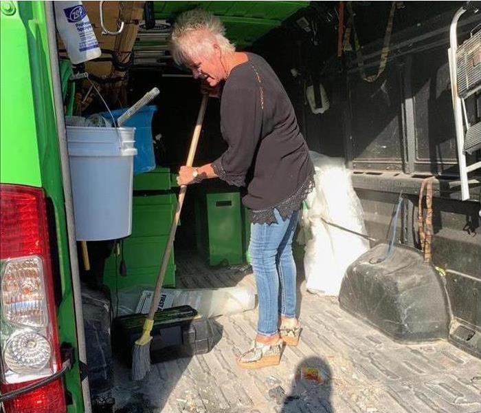 Businesswoman sweeping truck