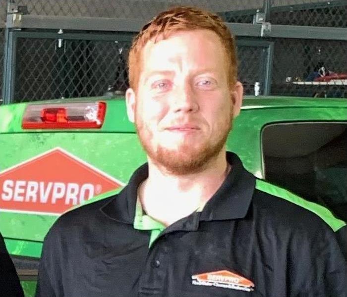 Man smiling with SERVPRO truck in background