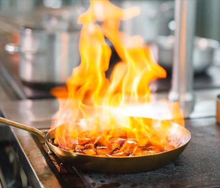 A saucepan is on fire. 